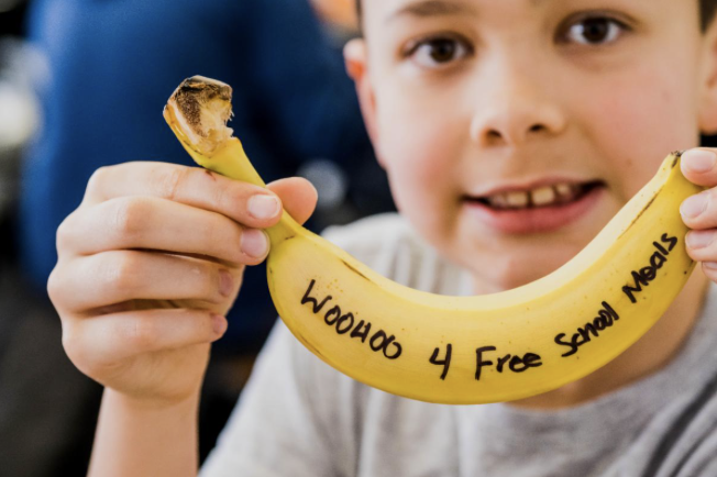 boy holding banana with message of woohoo 4 free school meals